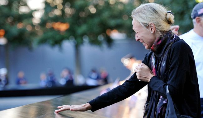 ** FILE ** Carrie Bergonia remembers her fiance, firefighter Joseph Ogren, who was killed in the terrorist attacks of Sept. 11, 2001, during a ceremony marking the 11th anniversary of the attacks at the National Sept. 11 Memorial at the World Trade Center site. (AP Photo/The Daily News, Todd Maisel, Pool)
