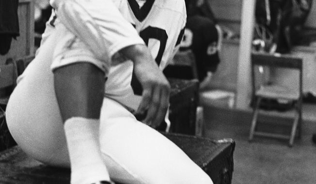 Sam Huff, famed by the Associated Press as defensive player of the week for the National Football League in the Washington Redskins locker room in Washington on Sept. 25, 1969. Huff made 12 tackles and five assists Sunday for Washington in a 26-20 defeat of New Orleans. (AP Photo/Charles Gorry)