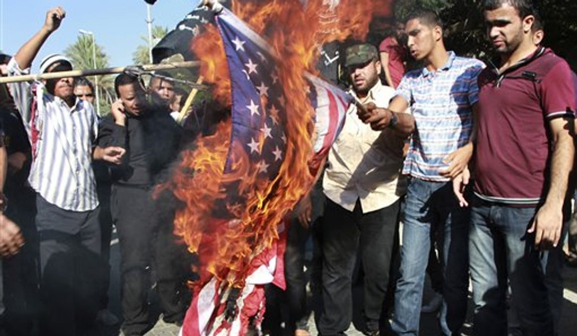 **FILE** Palestinians burn a U.S. flag during a protest against the movie, &quot;Innocence of Muslims,&quot; near the United Nations office in Gaza City, Wednesday, Sept. 12, 2012. Muslim anger over perceived Western insults to Islam has exploded several times, most recently in Tuesday&#x27;s attacks against U.S. diplomatic posts in the Middle East in which U.S. ambassador to Libya Chris Stevens and three other Americans were killed. (AP Photo/Adel Hana)