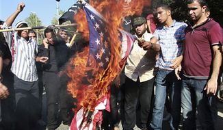 **FILE** Palestinians burn a U.S. flag during a protest against the movie, &quot;Innocence of Muslims,&quot; near the United Nations office in Gaza City, Wednesday, Sept. 12, 2012. Muslim anger over perceived Western insults to Islam has exploded several times, most recently in Tuesday&#39;s attacks against U.S. diplomatic posts in the Middle East in which U.S. ambassador to Libya Chris Stevens and three other Americans were killed. (AP Photo/Adel Hana)