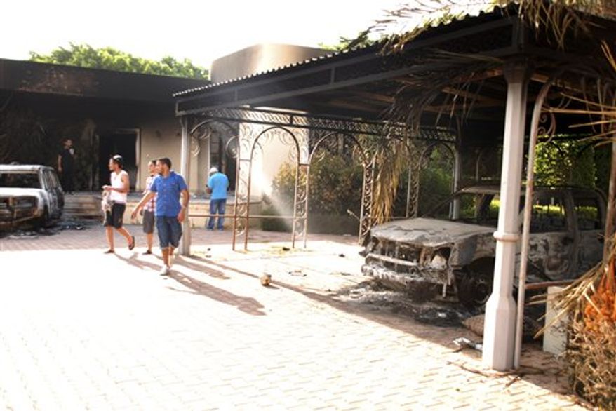 ** FILE ** Libyans walk on the grounds of the gutted U.S. Consulate in Benghazi, Libya, after an attack that killed four Americans, including U.S. Ambassador J. Christopher Stevens, on Wednesday, Sept. 12, 2012. (AP Photo/Ibrahim Alaguri)