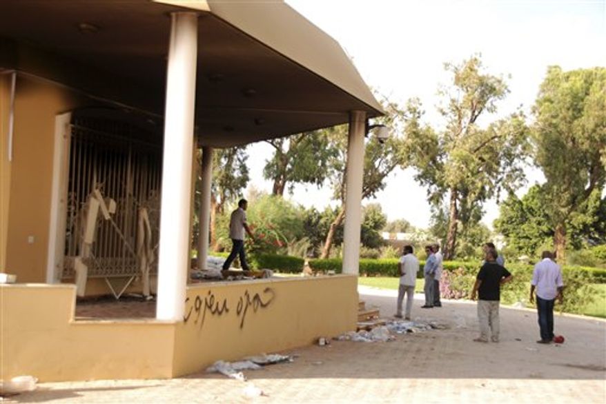 ** FILE ** Libyans gather at the gutted U.S. consulate in Benghazi, Libya, after an attack that killed four Americans, including Ambassador Chris Stevens, Wednesday, Sept. 12, 2012. (AP Photo/Ibrahim Alaguri)