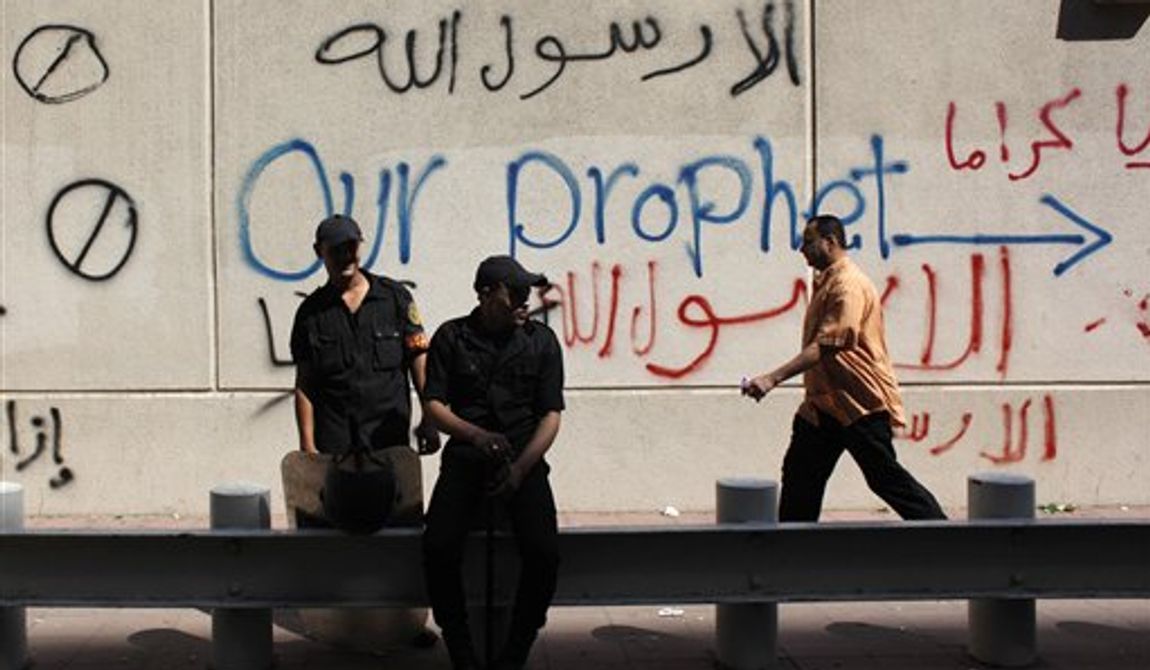 Egyptian soldiers stand guard in front of the U.S. embassy in Cairo, Egypt, Wednesday, Sept. 12, 2012. An Israeli filmmaker based in California went into hiding after his movie attacking Islam&#x27;s prophet Muhammad sparked angry assaults by ultra-conservative Muslims in Egypt. Arabic on the wall reads, &quot;anyone but God&#x27;s prophet.&quot; (AP Photo/Nasser Nasser)