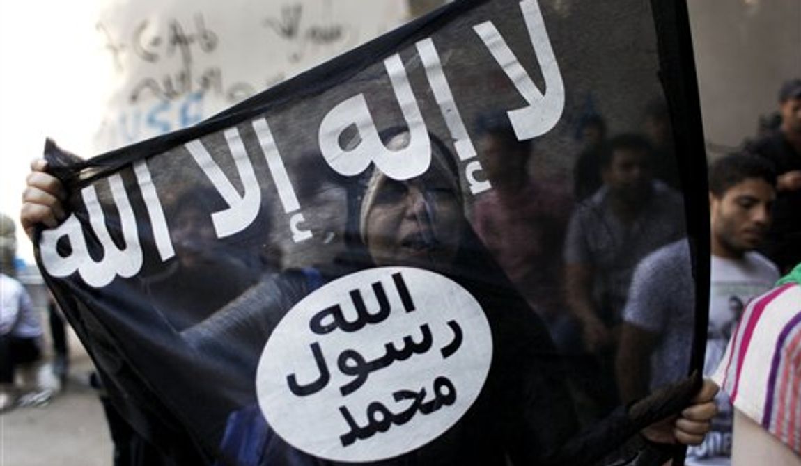 An Egyptian woman holds a black flag with Islamic inscription in Arabic that reads, &quot;No God but Allah, and Mohammed is his prophet,&quot; in front of the U.S. embassy in Cairo, Egypt, Wednesday, Sept. 12, 2012. An Israeli filmmaker based in California went into hiding after his movie attacking Islam&#x27;s prophet Muhammad sparked angry assaults by ultra-conservative Muslims in Egypt. (AP Photo/Nasser Nasser)

