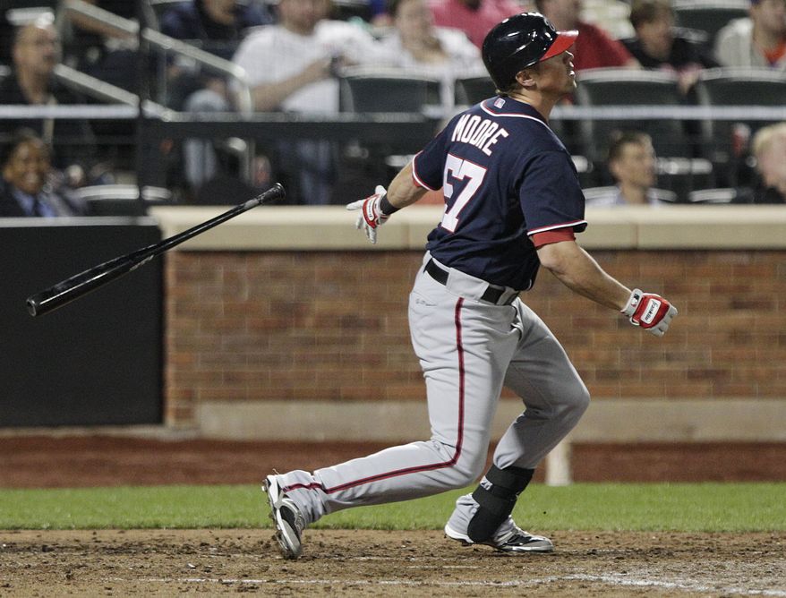 Tyler Moore of the Washington Nationals follows through on a two-run home run during the seventh inning of a baseball game against the New York Mets on Tuesday, Sept. 11, 2012, in New York. (AP Photo/Frank Franklin II)