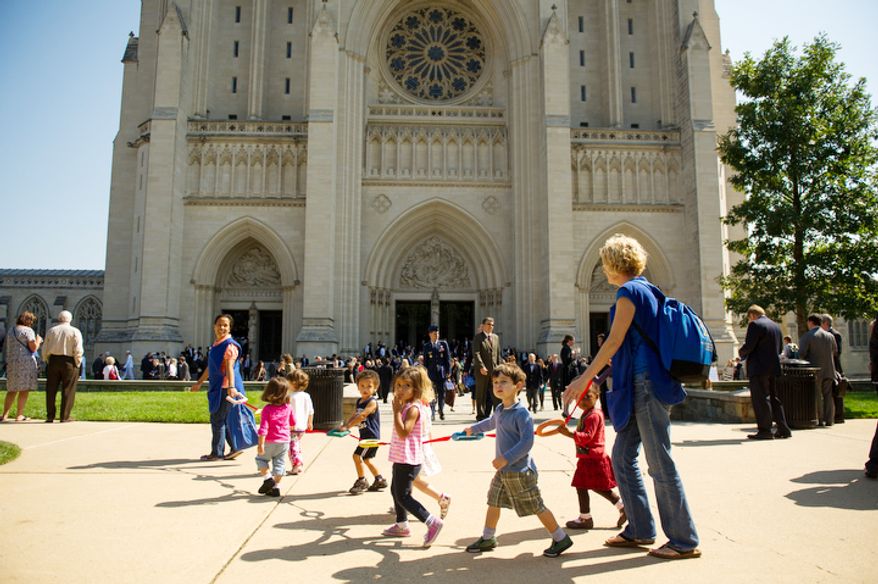 Children walk past the National Cathedral as attendees file out of the cathedral following a memorial service for Neil Armstrong, Washington, D.C., Thursday, September 13, 2012. (Andrew Harnik/The Washington Times)