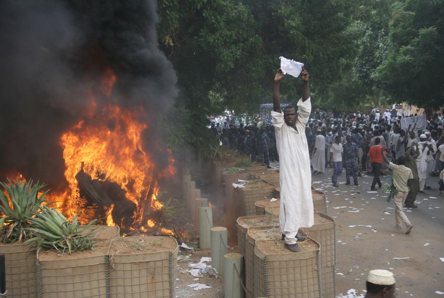 A Sudanese protester stands on a barricade during a demonstration in Khartoum, Sudan, on Sept. 14, 2012, as anger continued to spread across the Muslim world about a film ridiculing Islam's Prophet Muhammad. Germany's Foreign Minister said the country's embassy in Khartoum has been stormed by protesters and set partially on fire. (Associated Press)