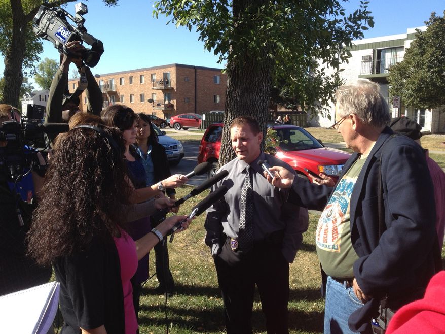Lt. Joel Vettel of the Fargo Police Department talks to the media near the North Dakota State University campus in Fargo, N.D., following a bomb threat that forced the evacuation of the campus on Friday, Sept. 14, 2012. Thousands of people streamed off university campuses in Texas and North Dakota on Friday after phoned-in bomb threats prompted evacuations and officials warned students and faculty to get away as quickly as possible. No bombs had been found on either campus by midmorning and it was not clear whether the threats were related. (AP Photo/The Forum, Ryan Babb)