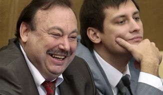 Russian opposition lawmaker Gennady Gudkov, left, and his son Dmitry react while listing during a plenary session of the State Duma, the lower parliament chamber, in Moscow, Russia, Friday, Sept. 14, 2012. Russia&#39;s lower house of parliament is voting Friday, Sept. 14, 2012, to expel Gudkov, who has angered the Kremlin with his scathing criticism and participation in opposition rallies. (AP Photo/Mikhail Metzel)