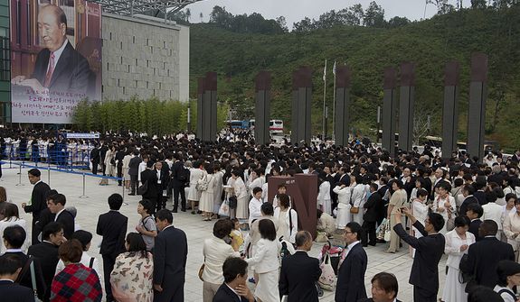 Thousands of mourners line up outside the stadium at the Cheong Shim Peace World Center in Gapyeong, Korea on Saturday, Sept. 15, 2012 for the Seonghwa, or ascension, ceremony, known as the traditional funeral in western terms, for the late Rev. Sun Myung Moon. Thousands of mourners from countries around the world came to witness the event and say goodbye to the head of the Unification Church. Some 15,000 fit into the stadium, where the funeral was held, with another 10,000 to 15,000 expected to be watching live simulcasts around the complex. (Barbara L. Salisbury/The Washington Times)
