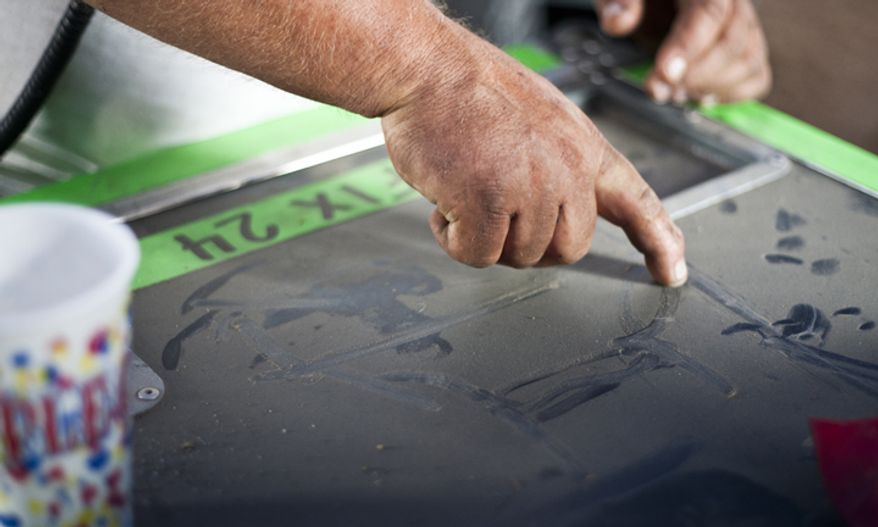 Mike Leclair, tent operator, draws a diagram of how wind can take down the Big Top tent of the Big Apple Circus. Friday, 14 September, 2012 in Dulles, Virginia. (Craig Bisacre/The Washington Times)