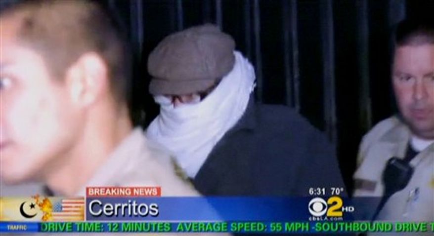 In this image from video provided by CBS2-KCAL9, Nakoula Basseley Nakoula, the man behind the anti-Muslim movie that has inflamed the Middle East, is escorted by Los Angeles County sheriff's deputies from his home, early Saturday, Sept. 15, 2012, in Cerritos, Calif. Nakoula, 55, was interviewed by federal probation officers at a Los Angeles sheriff's station but was not arrested or detained, authorities said early Saturday. (AP Photo/CBS2-KCAL9)