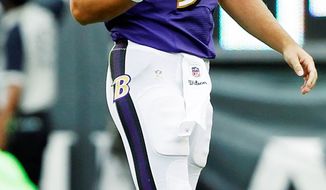 Baltimore quarterback Joe Flacco walks off the field after throwing incomplete to Ray Rice on fourth and 1 on Baltimore’s last drive of the game. Flacco was 22 of 42 for 232 yards with one touchdown and one interception in the Ravens’ 24-23 loss. (Associated Press)