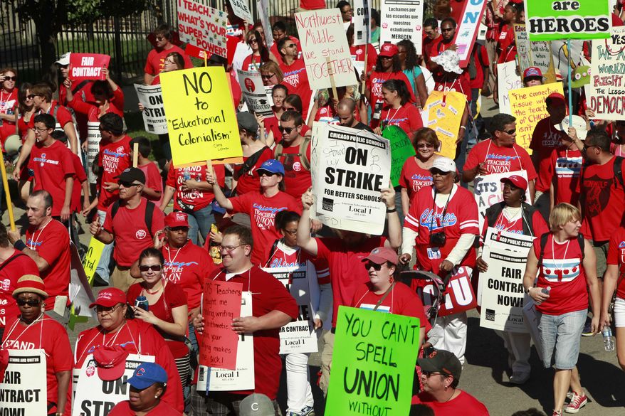 Striking schoolteachers march after a rally on Saturday, Sept. 15, 2012, in Chicago. (AP Photo/Sitthixay Ditthavong)