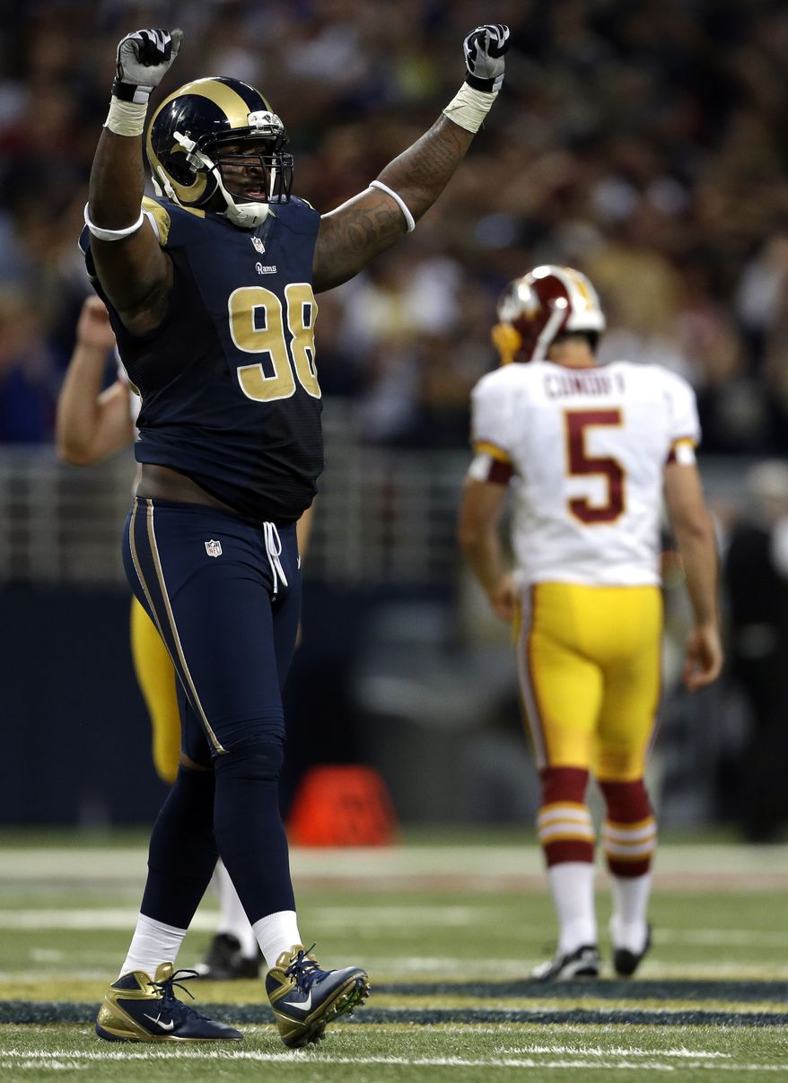 St. Louis Rams' Kendall Langford, left, celebrates after Washington Redskins kicker Billy Cundiff, right, missed a 62-yard field goal-attempt during the fourth quarter of an NFL football game on Sunday, Sept. 16, 2012, in St. Louis. The Rams won 31-28. (AP Photo/Jeff Roberson)