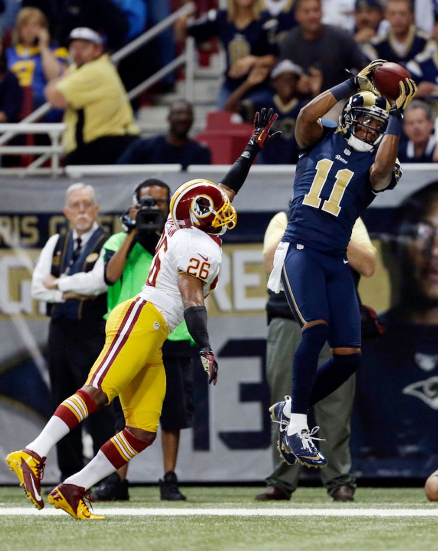 St. Louis Rams wide receiver Brandon Gibson, right, catches a pass as Washington Redskins cornerback Josh Wilson defends during the first quarter. Gibson was ruled out of bounds on the play. (AP Photo/Jeff Roberson)