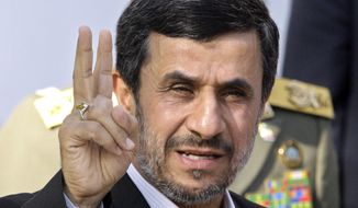 FILE - In this Sept. 1, 2012, file photo, Iranian President Mahmoud Ahmadinejad flashes a victory sign in Tehran, Iran. (AP Photo/Vahid Salemi, File)