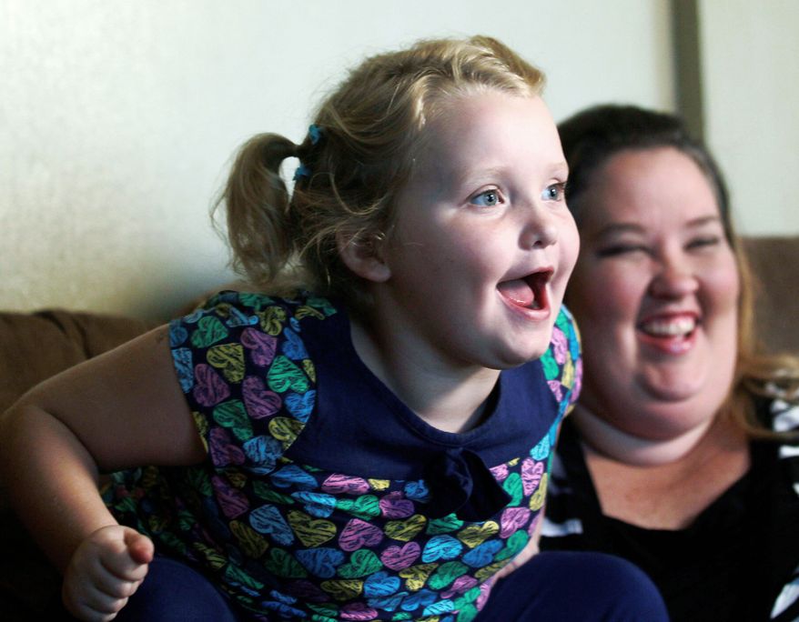 Alana “Honey Boo Boo” Thompson enthuses during an interview that includes her mother, June Shannon, at their home in McIntyre, Ga. The child is known for outrageous catchphrases on her TLC reality TV show, “Here Comes Honey Boo Boo.” (Associated Press)