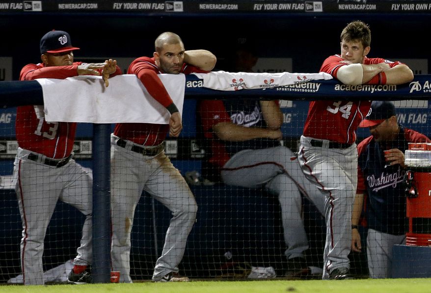 Danny Espinosa, center, will get an MRI on his aching left shoulder on Monday. (Associated Press)