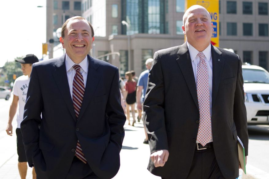 NHL commissioner Gary Bettman, left, and deputy commisioner and chief legal officer Bill Daly, Deputy Commissioner leave the NHLPA offices in Toronto on Wednesday, Aug. 22, 2012. Negotiations continue between the NHL and the NHLPA over collective bargaining as both sides try to avoid a potential lockout. (AP Photo/The Canadian Press, Chris Young)