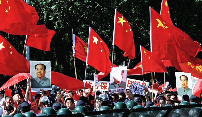 Protesters march outside the Japanese Embassy in Beijing on Tuesday. The 81st anniversary of a Japanese invasion brought a fresh wave of anti-Japan demonstrations, with thousands venting anger over the colonial past and a current dispute involving contested islands in the East China Sea. (Associated Press)