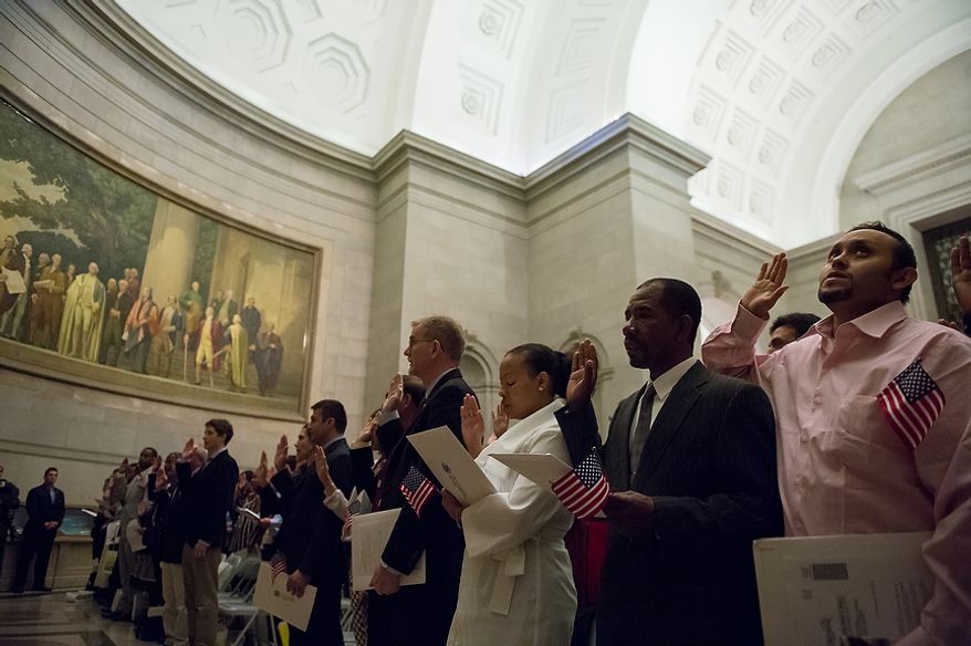Petitioners are sworn in as U.S. citizens on Sept. 17, 2012, at the National Archives Building in Washington, during a naturalization ceremony to commemorate the 225th anniversary of the signing of the U.S. Constitution. (Andrew Harnik/The Washington Times)