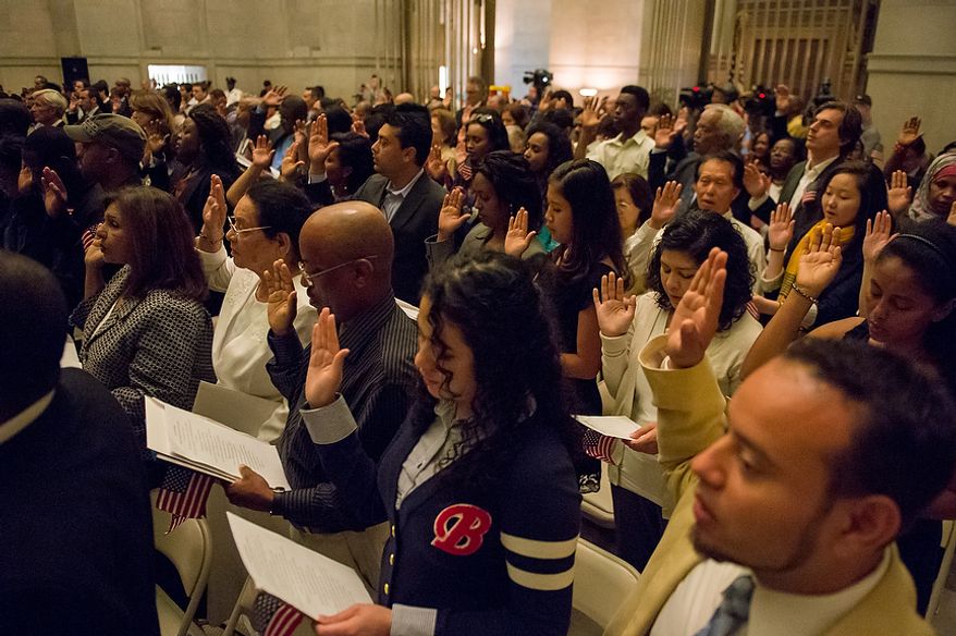 Petitioners are sworn in as U.S. citizens on Sept. 17, 2012, at the National Archives Building in Washington, during a naturalization ceremony to commemorate the 225th anniversary of the signing of the U.S. Constitution. (Andrew Harnik/The Washington Times)