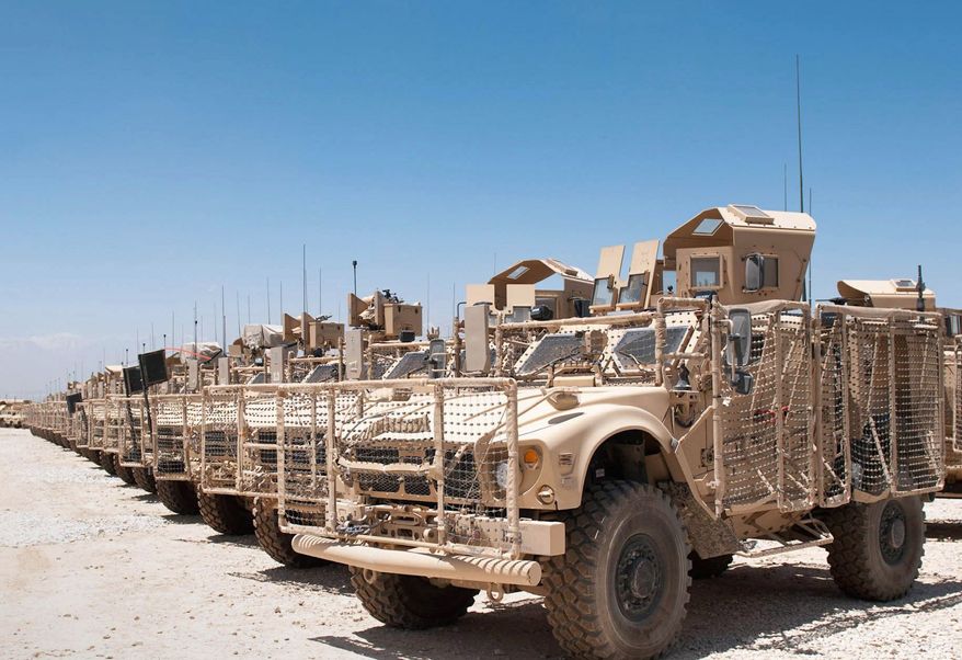 U.S. military vehicles have been placed in a yard at the Kandahar Air Field for shipment back to the United States or other locations as part of a 23,000 reduction in the U.S. troop level by Sept. 30. (Associated Press)