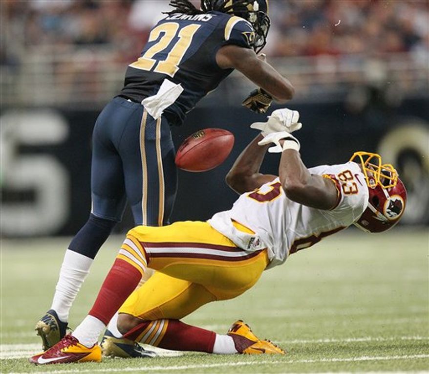 Fred Davis absorbs a helmet-to-helmet hit from Rams CB Janoris Jenkins / Associated Press