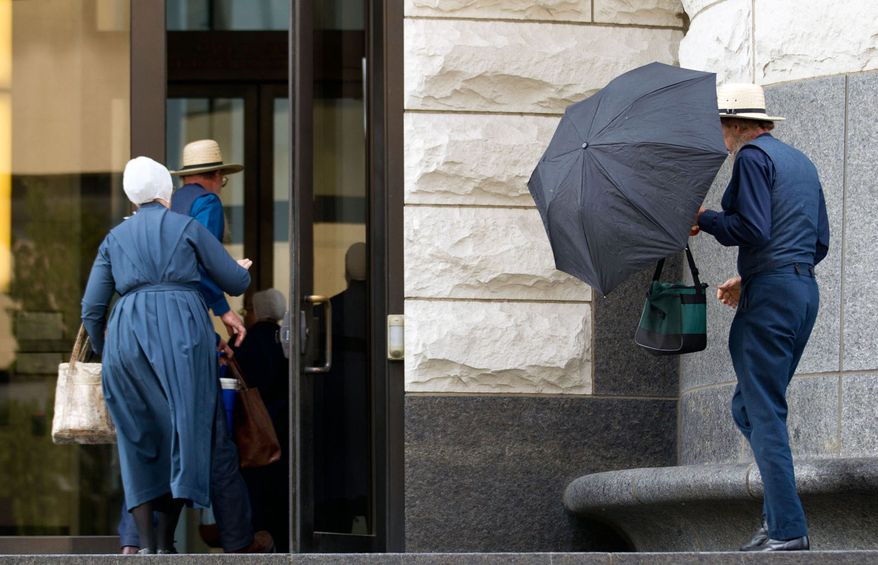 Amish enter the federal courthouse in Cleveland on Thursday, Sept. 20, 2012, as a jury began the fifth day of deliberations in the trial of 16 Amish accused of hate crimes in hair- and beard-cutting attacks against fellow Amish in Ohio. (AP Photo/Scott R. Galvin)