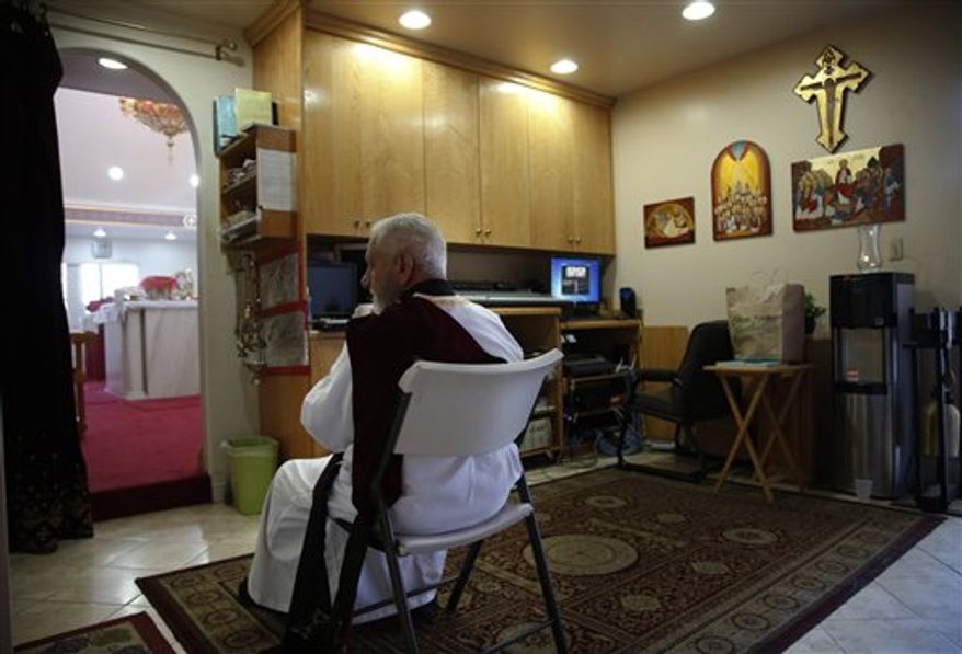 Archy Jacob sits in a sound room during a Mass at St. Mary and St. Verena Orthodox Coptic Church in Anaheim, Calif., Wednesday, Sept. 19, 2012. (AP Photo/Jae C. Hong)