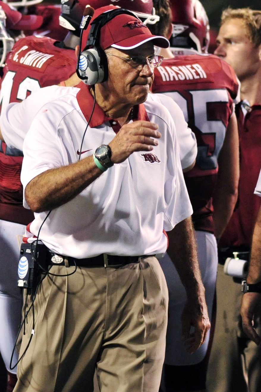 Arkansas coach John L. Smith walks onto the field during a timeout in the second half of an NCAA college football game against Jacksonville State in Fayetteville, Ark., Saturday, Sept. 1, 2012. Arkansas won 49-24. (AP Photo/April L. Brown)