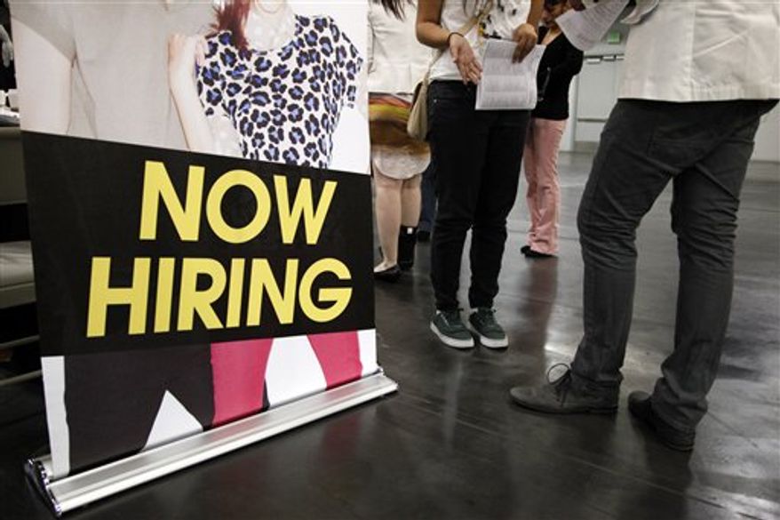 ** FILE ** In this June 13, 2012, file photo, a job seeker talks to a recruiter at a job fair expo in Anaheim, Calif. (AP Photo/Jae C. Hong, File)