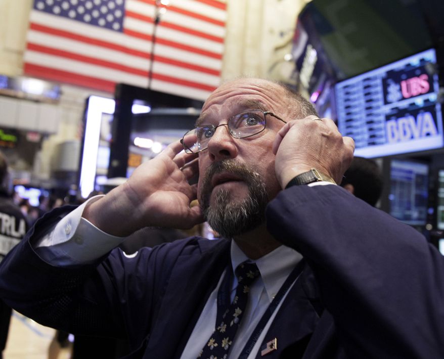 Trader Frederick Reimer works on the floor of the New York Stock Exchange on Thursday, Sept. 20, 2012, in New York. (AP Photo/Richard Drew)