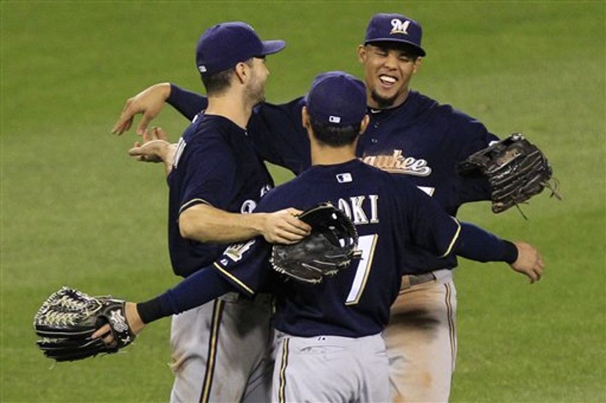Milwaukee Brewers left fielder Ryan Braun, left, Milwaukee Brewers center fielder Carlos Gomez, right, and Milwaukee Brewers right fielder Norichika Aoki (7) celebrate after a 9-7 win over the Pittsburgh Pirates in a baseball game in Pittsburgh, Thursday, Sept. 20, 2012. (AP Photo/Gene J. Puskar)
