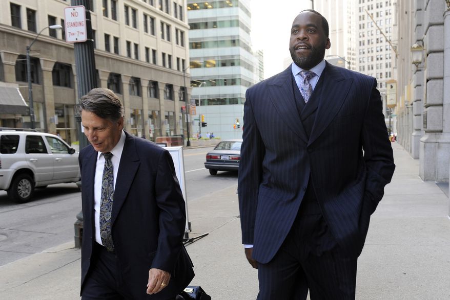 **FILE** Former Detroit Mayor Kwame Kilpatrick walks to federal court on Sept. 6, 2012 in Detroit with attorney Jim Thomas. Kilpatrick, his father Bernard, former city water boss Victor Mercado and Kilpatrick associate Bobby Ferguson are accused of a sweeping corruption scheme. (Associated Press/Detroit News)