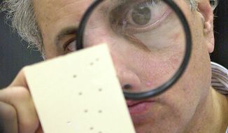 Eyestrain was starting to get to Judge Robert Rosenberg until he started bringing a magnifying glass to his work examining disputed ballots at the Broward County Courthouse in Fort Lauderdale, Fla., after the 2000 presidential election. He said he’s still recognized thanks to photos of him. (Associated Press)