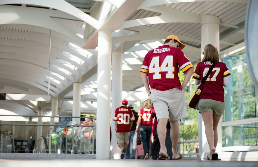 Fans walk to the Redskins game from the Morgan Boulevard Metro Station on Sunday. Taking Metro is an option for fans getting to and leaving the game, but they still face a walk. (Andrew Harnik/The Washington Times)