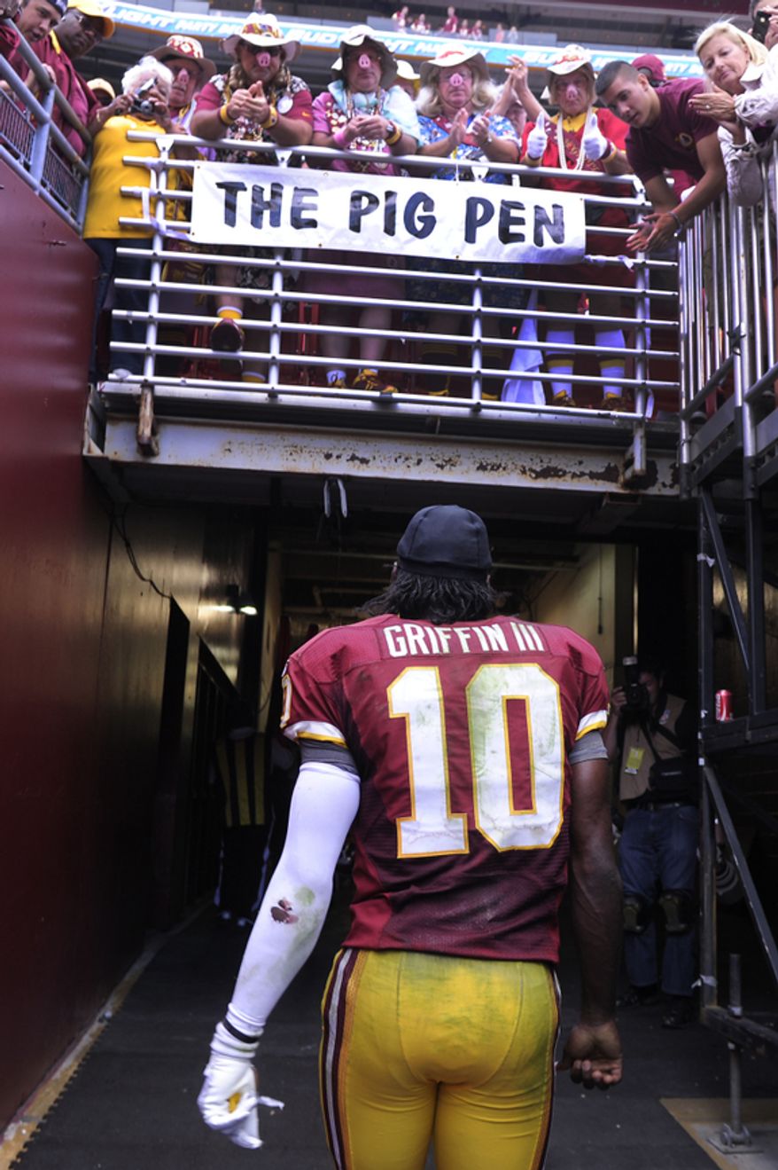 Washington Redskins quarterback Robert Griffin III (10) walks off the field after losing to the Bengals 38-31 at FedEx Field, Landover, Md., Sep. 23, 2012. (Preston Keres/Special to The Washington Times)