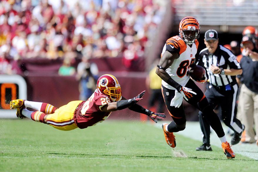 Cincinnati Bengals wide receiver Armon Binns (85) turns upfield past Washington Redskins cornerback Josh Wilson (26) for a 48-yard touchdown in the first quarter. (Preston Keres/Special to The Washington Times)
