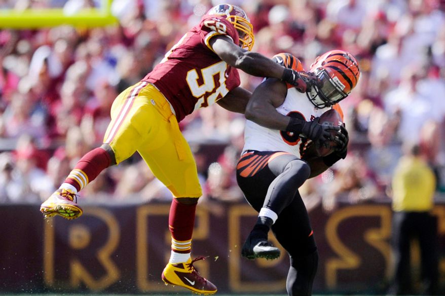 Cincinnati Bengals tight end Orson Charles (80) hauls in a 25-yard reception in front of Washington Redskins inside linebacker London Fletcher (59) for a first down in the fourth quarter. (Preston Keres/Special to The Washington Times)