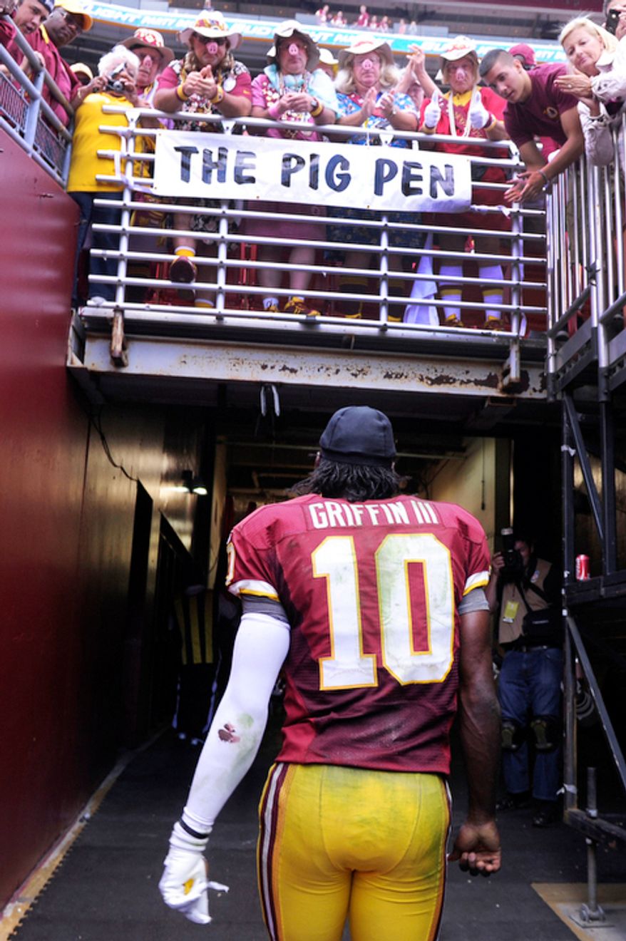Washington Redskins quarterback Robert Griffin III (10) walks off the field after losing to the Bengals 38-31 at FedEx Field, Landover, Md., Sep. 23, 2012. (Preston Keres/Special to The Washington Times)