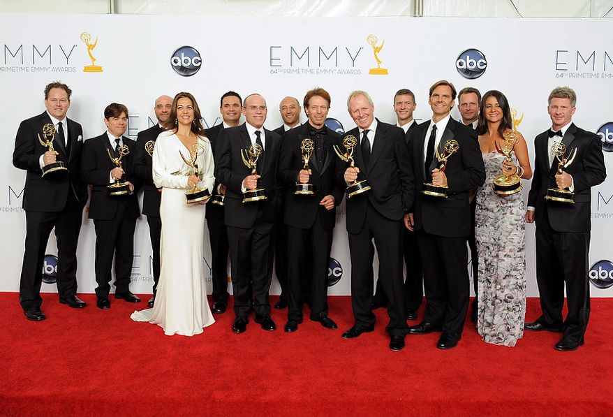 Producer Jerry Bruckheimer, center, winner Outstanding Reality-Competition Program for &quot;The Amazing Race&quot;, poses backstage at the 64th Primetime Emmy Awards at the Nokia Theatre on Sunday, Sept. 23, 2012, in Los Angeles. (Photo by Jordan Strauss/Invision/AP)