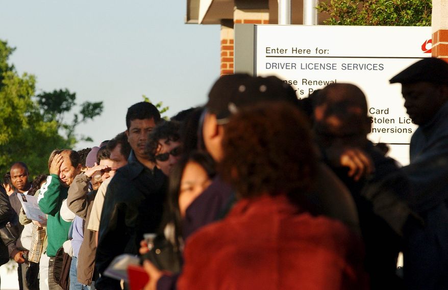 **FILE** Immigrants applying for driver's licenses wait at the doors of the Beltsville, Md., branch of Maryland's Motor Vehicle Administration in 2006. (The Washington Times)