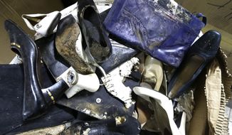 Branded high-heel shoes once worn by flamboyant former Philippine first lady Imelda Marcos sit among equally damaged shoes and bags in a section of the National Museum in Manila on Wednesday, Sept. 19, 2012. (AP Photo/Bullit Marquez)