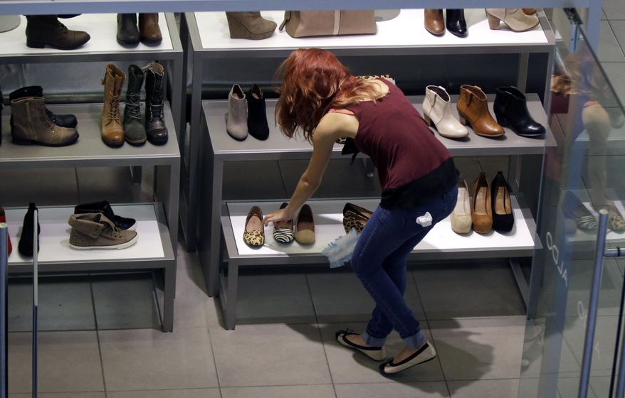 **FILE** A clerk straightens out her display at a shoe store in Salem, N.H., on Sept. 10, 2012. (Associated Press)