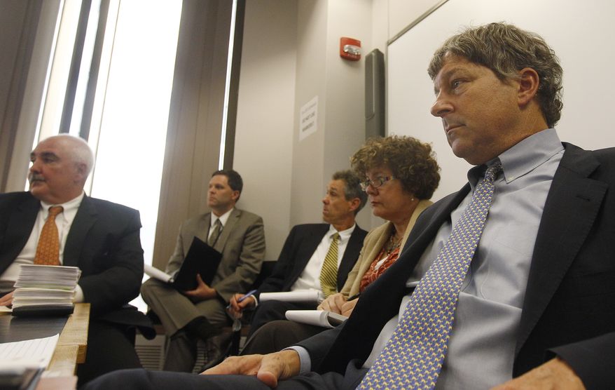 David Meier (right), special consul to Massachusetts Gov. Deval Patrick and leader of the review of drug convictions that might have been compromised at a state police drug testing lab, conducts a meeting at the Department of Public Safety in Boston on Monday, Sept. 24, 2012. (AP Photo/Stephan Savoia)