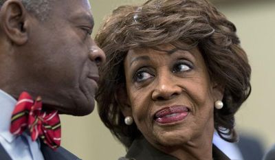 Rep. Maxine Waters, California Democrat, smiles Sept. 21, 2012, at her husband, Sidney Williams (left), during a House Ethics Committee hearing on Capitol Hill in Washington after learning she had been cleared of allegations that she steered a $12 million federal bailout to a bank where her husband owns stock. (Associated Press)