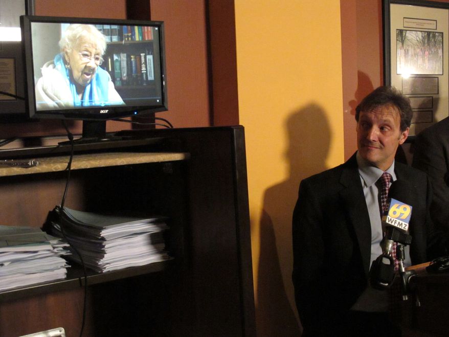 **FILE** Viviette Applewhite, 93, a plaintiff in a lawsuit against Pennsylvania's tough new voter identification law, speaks May 1, 2012, in a video played during a news conference in the Pennsylvania state Capitol in Harrisburg, Pa., as one of her lawyers, Witold J. Walczak of the American Civil Liberties Union, looks on. (Associated Press)