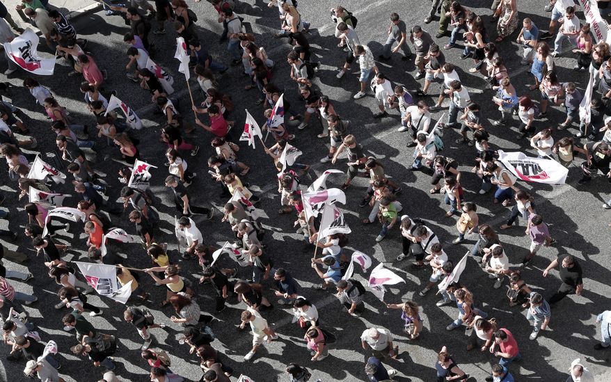 Protesters from Greek Communist Party-affiliated unions march in front of the Greek parliament in Athens on Wednesday, Sept. 26, 2012. (AP Photo/Dimitri Messinis)